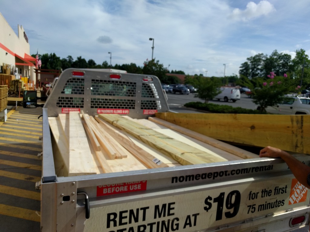 A truck-load of lumber consisting of pre-cut plywood and 2"x4".